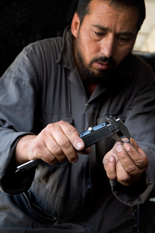 Afghan Air Force 1st Lt. Musa, Kabul Air Wing electrician, measures a fuse from an Mi-17 helicopter instrument panel during routine maintenance and repair at Kabul International Airport, Afghanistan, July 18, 2013. Intermediate maintenance inspection advisors from the 440th Air Expeditionary Advisory Squadron are focusing efforts on building stronger quality control programs across AAF aircraft maintenance. (U.S. Air Force Photo/Master Sgt. Ben Bloker)
