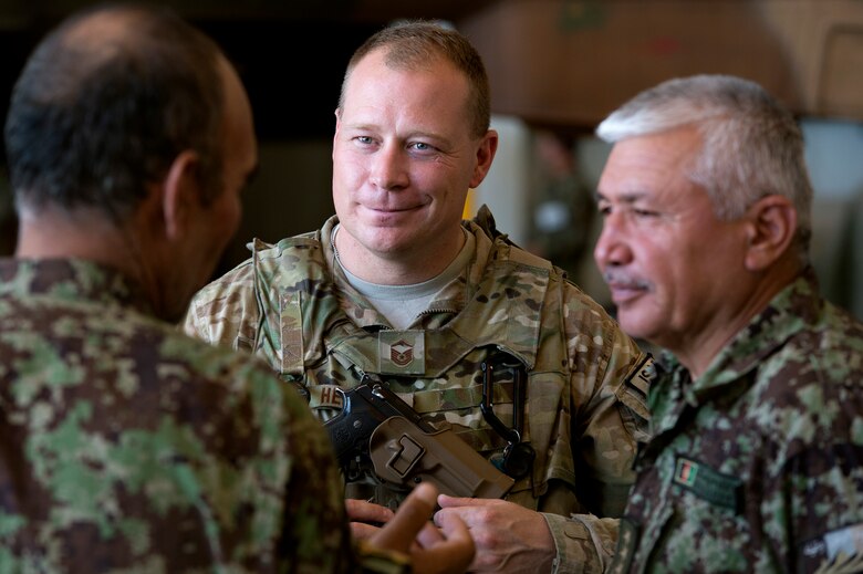 Master Sgt. William Hensley, 440th Air Expeditionary Advisory Squadron aircraft maintenance advisor, speaks with Moosa Jan and Baqi Khan, Afghan Air Force maintenance commanders, during routine Mi-17 helicopter inspections at Kabul International Airport, Afghanistan, July 18, 2013. Hensley is on his second tour as an Mi-17 advisor. Intermediate maintenance inspection advisors from the 440th AEAS are focusing efforts on building stronger quality control programs across AAF aircraft maintenance. Hensley is currently deployed from Whiteman Air Force Base, Mo., and hails from Ravenna, Ohio. (U.S. Air Force Photo/Master Sgt. Ben Bloker)
