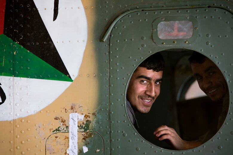 Afghan Air Force Sgt. Naqeebullah, Kabul Air Wing engine mechanic, peers through an Mi-17 helicopter window in a maintenance hangar at Kabul International Airport, Afghanistan, July 18, 2013. Intermediate maintenance inspection advisors from the 440th Air Expeditionary Advisory Squadron are focusing efforts on building stronger quality control programs across AAF aircraft maintenance. (U.S. Air Force Photo/Master Sgt. Ben Bloker)

