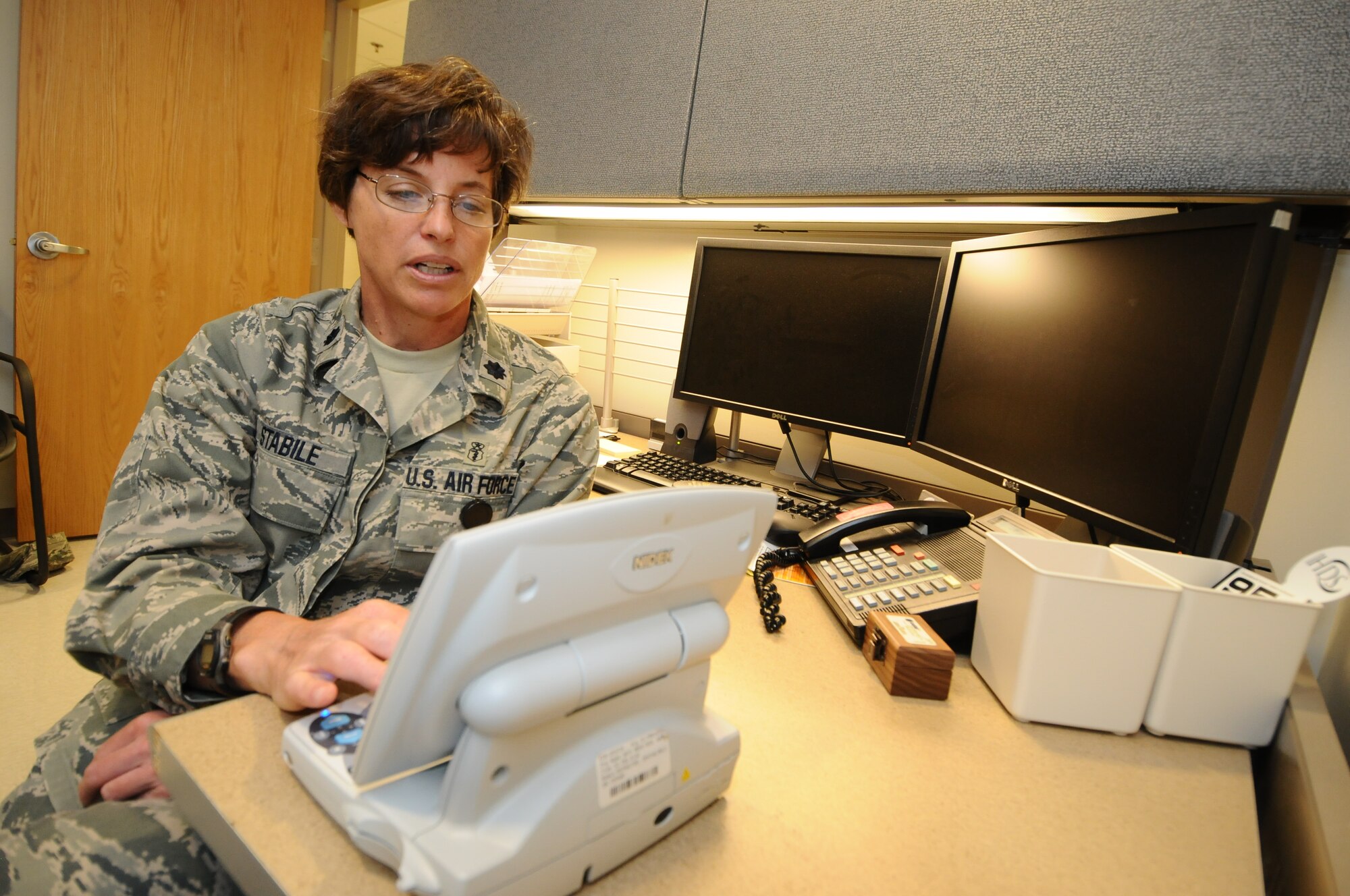 Lt. Col. Christine Stabile, 36th Medical Support Squadron commander, looks for the correct prescription for a patient’s eyeglasses during a refractor test July 31, 2013, on Andersen Air Force Base, Guam. The 36th  Medical Group upgraded to the an electronic refractor, which is more efficient than the previous manual refractors.. (U.S. Air Force photo by Airman 1st Class Emily A. Bradley/Released)