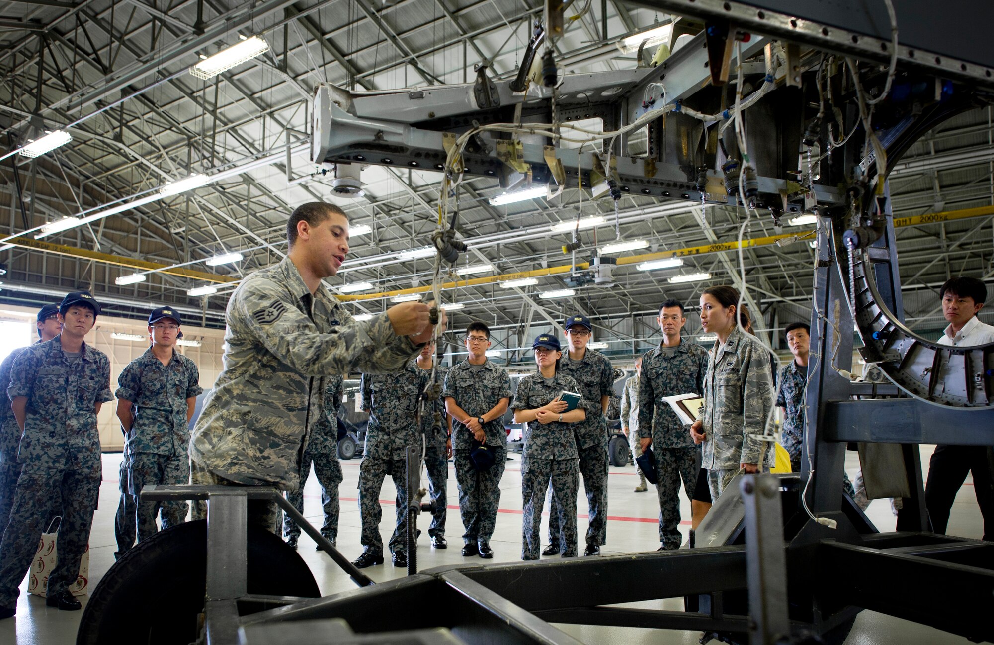 YOKOTA AIR BASE, Japan -- Japan Air Self-Defense Force maintenance officers receive a briefing during a tour of the 374th Maintenance Group at Yokota Air Base, Japan, July 26, 2013. The visiting officers are taking part in an officer exchange program, which gives them the chance to see how maintainers at Yokota work. (U.S. Air force photo by Staff Sgt. Stacy Moless) 