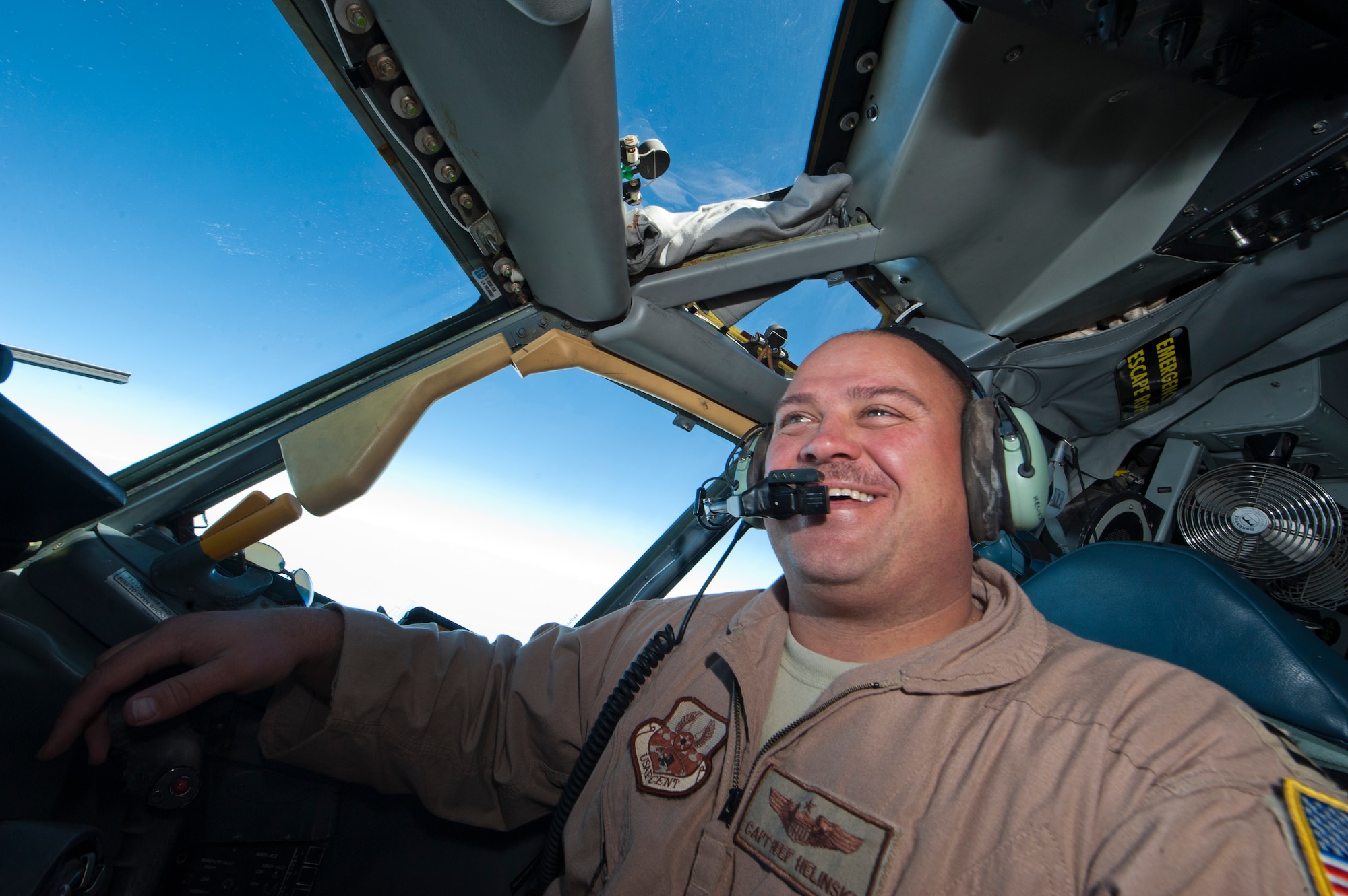 Capt. Brent Helinski, 22nd Expeditionary Air Refueling Squadron, laughs as he pilots a KC-135 Stratotanker out of Transit Center at Manas, Kyrgyzstan, July 25, 2013. Helinski is an instructor pilot and assistant director of operations, deployed out of the 92nd Aircraft Refueling Squadron, Fairchild Air Force Base, Wash. (U.S. Air Force photo/Staff Sgt. Robert Barnett)