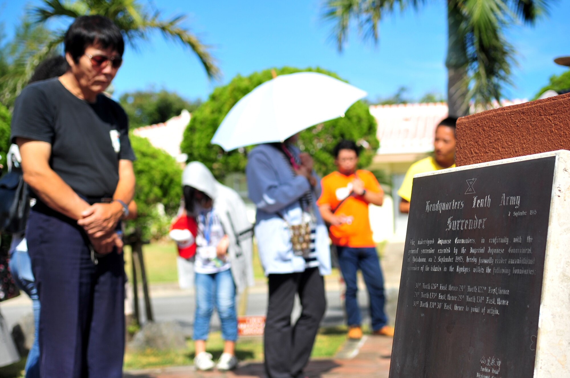 An Okinawa City resident views a memorial at the Peace Garden on Kadena Air Base, Japan, July 30, 2013. The monument is in memory of the surrender of the Tenth Army of Japan headquarters, and is dedicated to the importance of everlasting peace and understanding. (U.S. Air Force photo by Senior Airman Amber E. N. Jacobs/Released)