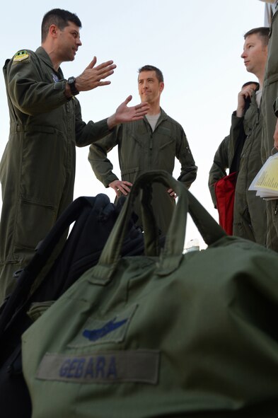 Col. Andrew Gebara, 2nd Bomb Wing commander, talks with aircrew members before a flight on Barksdale Air Force Base, La., July 29, 2013.  Aircrew from the 96th Bomb Squadron helped Gebara commemorate the 20th anniversary of his first flight in the B-52. A few of the crew members where in grade school when Gebara took his first flight in 1993. (U.S. Air Force photo/Senior Airman Micaiah Anthony)