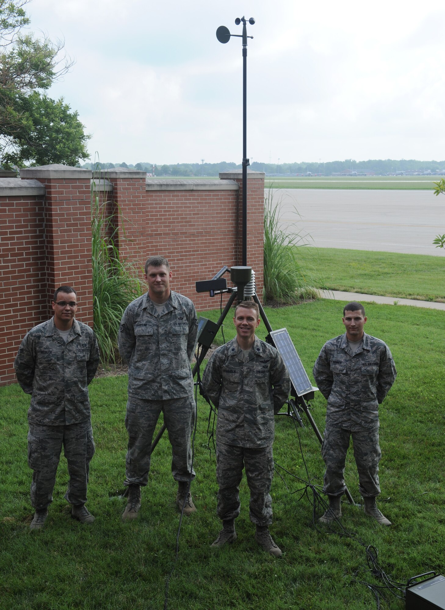 Lt. Col. George Granholm, 375th Operations Support Squadron commander, visits with weather forecasters, Staff Sgt. Joshua Hartline, Senior Airmen Matthew Fenner and Senior Airman Blake Medler July 22 on base.  Granholm assumed command of the 375th OSS July 3.  (U.S. Air Force photo/Staff Sgt. Maria Bowman)