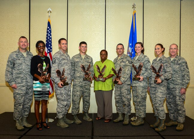 (Left)Col. Richard McComb, Joint Base Charleston commander, and (Right) Chief Master Sgt. Al Hannon, 628th Air Base Wing command chief, stand with the 628th Air Base Wing 2nd Quarter Award Winners during the monthly Promotion/Quarterly Awards ceremony July 30, 2013, at Joint Base Charleston – Air Base, S.C. (Left to Right), Jennifer Green, Civilian of the Quarter Category II, Master Sgt. Eric Cicogna, Senior Noncommissioned Officer of the Quarter, Senior Airman Kelby Rosengarten, Airman of the Quarter, Joyce Martin, Civilian of the Quarter Category I, Tech. Sgt. Darren Perry, Noncommissioned Officer of the Quarter, Airman 1st Class Kathryn Raethel, Honor Guard Member of the Quarter and Airman Jennie Short, Volunteer of the Quarter. Award Winners not pictured include 1st Lt. Htein Lin, Junior Company Grade Officer and Capt. Jonathan Blount, Senior Company Grade Officer. (U.S. Air Force photo/ Senior Airman Dennis Sloan)