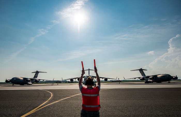 Senior Airman Brandi Barentine, 437th Aircraft Maintenance Squadron crew chief, marshals a C-17 Globemaster III July, 30, 2013, at Joint Base Charleston – Air Base, S.C. (U.S. Air Force photo/ Senior Airman Dennis Sloan)