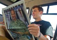 Amerian country singer Scotty McCreery reads an edition of the Northern Sentry at Minot Air Force Base, N.D., July 25. McCreery recieved a base tour the day after his USO concert for Airmen and their families. (U.S. Air Force photo/Senior Airman Brittany Y. Auld)