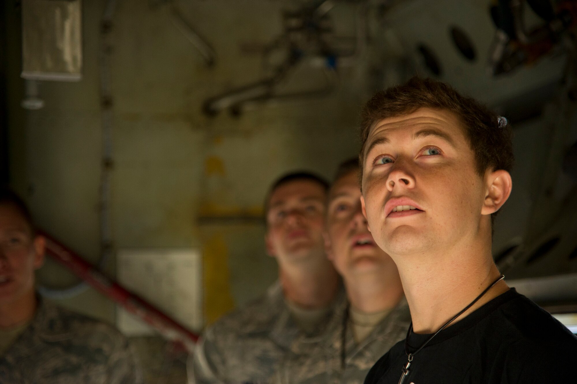 Amerian country singer Scotty McCreery takes a tour of a B-52H Stratofortress static display, July 25. McCreery recieved a base tour the day after his USO concert for Airmen and their families. (U.S. Air Force photo/Senior Airman Brittany Y. Auld)