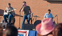 Country singer Scotty McCreery performs for Minot Air Force Base Airmen and their families during his visit here, July 24. During his visit, McCreery performed the free concert, which was also his very first USO show. (U.S. Air Force photo/Airman 1st Class Apryl Hall)