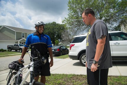 Staff Sgt. William Barrios, 628th Security Forces Squadron patrolman, talks to Jonathon Cabrera, husband of Consuelo Cabrera, a 628th Medical Group dental hygiene student, as he takes a break from patrolling the base’s residential area, July 30, 2013, at Joint Base Charleston – Air Base, S.C. Bicycle patrolmen can maneuver and respond more quickly than an automobile. This competency, in certain circumstances, allows patrolmen to respond to the installation's distress calls in a prompt and safe manner. (U.S. Air Force photo/Staff Sgt. Rasheen Douglas)