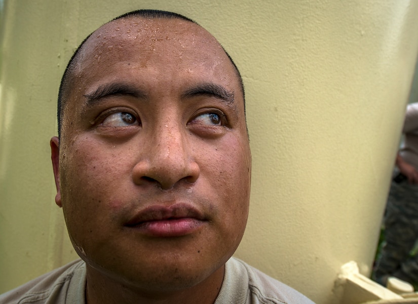 Senior Airman Michael Ang, 628th Civil Engineer Squadron water fuels system maintenance craftsman, rests at the bottom of a water tower after making the climb to the top and back down to perform a chlorine test July 29, at Joint Base Charleston – Air Base, S.C. The water tower is used for emergencies such as destruction from hurricanes or heavy storms. The water’s chlorine level was safe for human consumption. (U.S. Air Force photo/ Senior Airman Dennis Sloan)