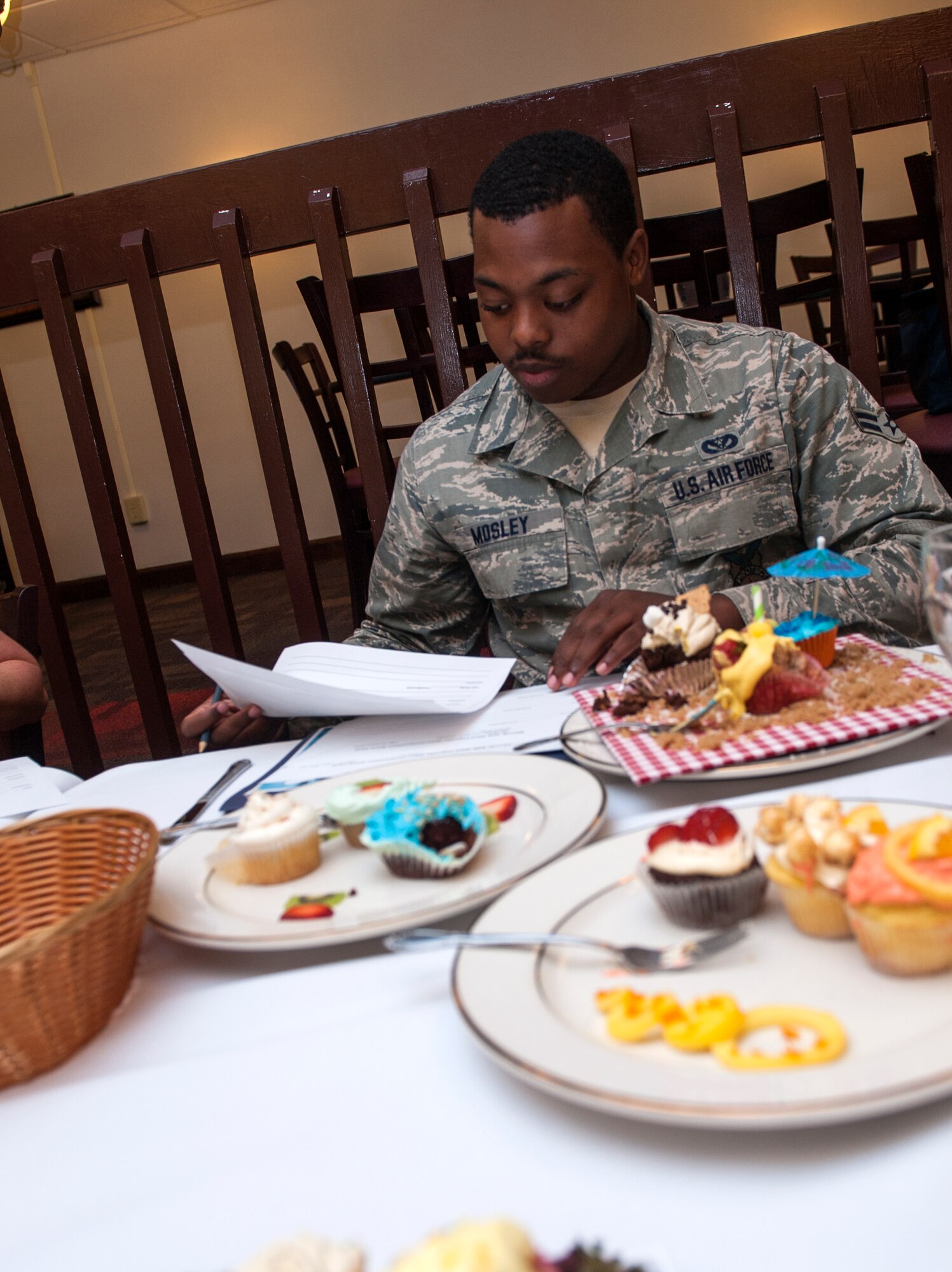 U.S. Air Force Airman 1st Class Anthony Mosley fills out a judging sheet during Cupcake Wars 3 at Moody Air Force Base, Ga., July 23, 2013. The theme for Cupcake Wars 3 was tropical, and at least one cupcake had to contain a tropical fruit such as mango, kiwi, pineapple, papaya, banana or oranges. (U.S. Air Force photo by Senior Airman Jarrod Grammel/Released)
