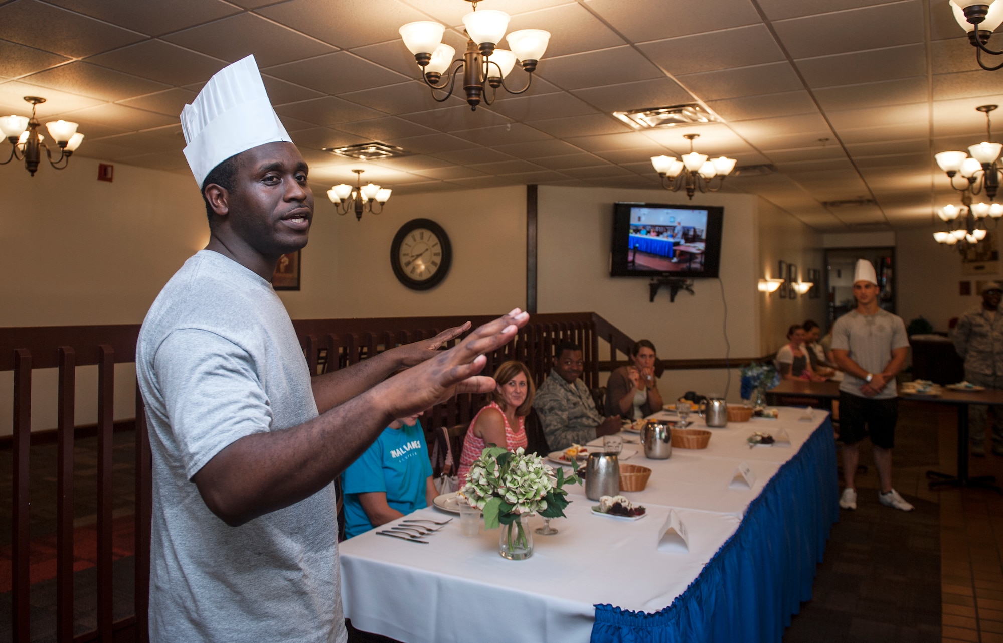 U.S. Air Force Staff Sgt. Phillip Burns II, Firehouse Cupcakes team member, describes his team’s cupcakes to the judges during Cupcake Wars 3 at Moody Air Force Base, Ga., July 23, 2013. Firehouse Cupcakes was the first male team to ever compete in Cupcake Wars. (U.S. Air Force photo by Senior Airman Jarrod Grammel/Released)
