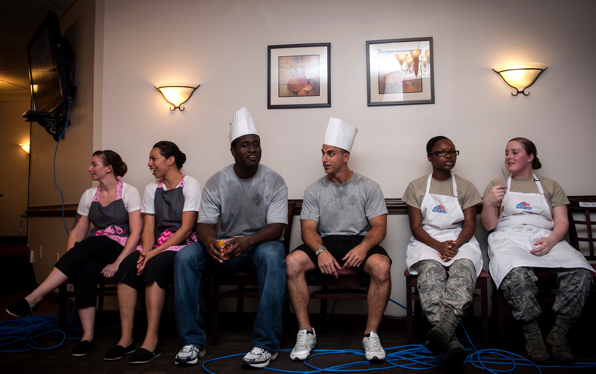 Teams wait for the judging to begin during Cupcake Wars 3 at Moody Air Force Base, Ga., July 23, 2013. Each two-person team had one hour to bake, decorate and plate their cupcakes for the judges. (U.S. Air Force photo by Senior Airman Jarrod Grammel/Released)
