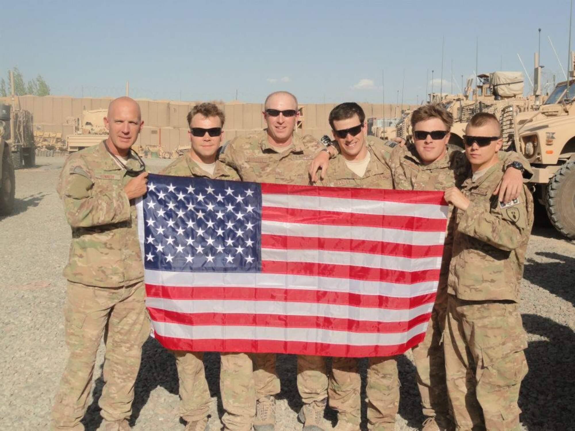 U.S. Air Force Tech. Sgt. Tracy Passerotti, 4th Civil Engineer Squadron explosive ordnance disposal (EOD) NCO in-charge of logistics, and Senior Airman Justin Beasley, 4th CES EOD craftsman, (center), pose for a group photo along with other EOD technicians while deployed to Afghanistan in support of OPERATION ENDURING FREEDOM, 2012. Passerotti’s outstanding contribution to the EOD career field as a civil engineering NCO earned him the 2012 Major General Eugene A. Lupia award. (Courtesy photo)