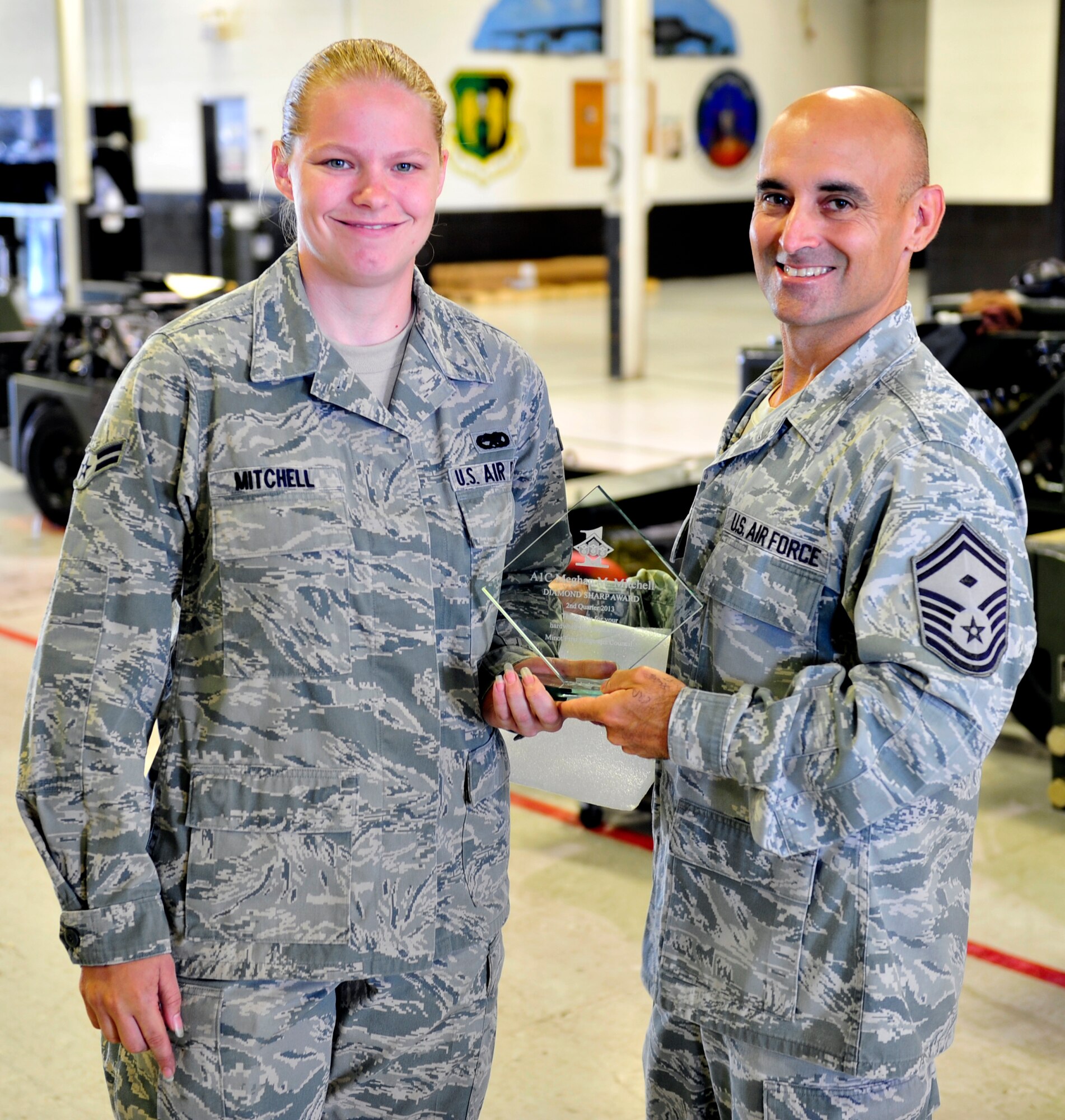 Airman 1st Class Megan Mitchell, assigned to the 5th Maintenance Squadron, earned the Diamond Sharp Award, July 24, 2013. Mitchell is currently a Dorm Resident Advisor. She earned the award for doing an outstanding job taking care of the Airmen in her dorm. She is always on top of dorm issues helping enforce dormitory standards. Mitchell has gone above and beyond keeping the first sergeants aware of concerns including quality of life matters. She has been in integral part of keeping morale high for the members who live in Dorm 276 and she has proven to be a great leader the first sergeants can count on. (U.S. Air Force photo/Airman 1st Class Kristoffer Kaubisch)