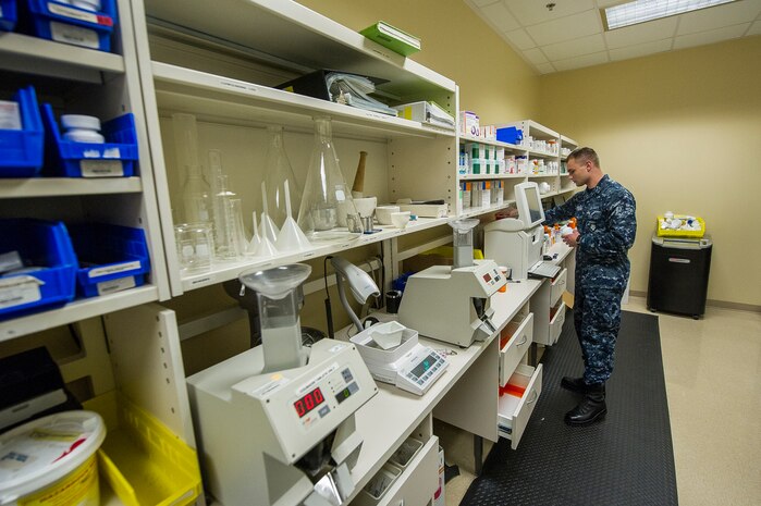 Seaman Colton Breininger, Naval Health Clinic Charleston hospital corpsman, refills prescriptions in the NHCC pharmacy, July 29, 2013, at Joint Base Charleston - Weapons Station, Goose Creek, S.C. NHCC provides quality healthcare services for approximately 12,000 beneficiaries throughout the LowCountry, including a sick call clinic for Sailors assigned to the Weapons Station. (U.S. Air Force photo/ Senior Airman George Goslin)