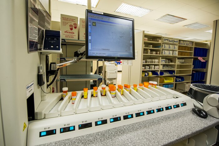 The ScriptPro Compact Robotic System automatic prescription speeds the time it takes to fill and refill prescriptions at  the Naval Health Clinic Charleston pharmacy, July 29, 2013, at Joint Base Charleston - Weapons Station, Goose Creek, S.C. The system automates the repetitive, manual tasks most subject to human error and can fill, label and deliver up to 150 prescriptions per hour. NHCC provides quality healthcare services for approximately 12,000 beneficiaries throughout the LowCountry, including a sick call clinic for Sailors assigned to the Weapons Station. (U.S. Air Force photo/ Senior Airman George Goslin)