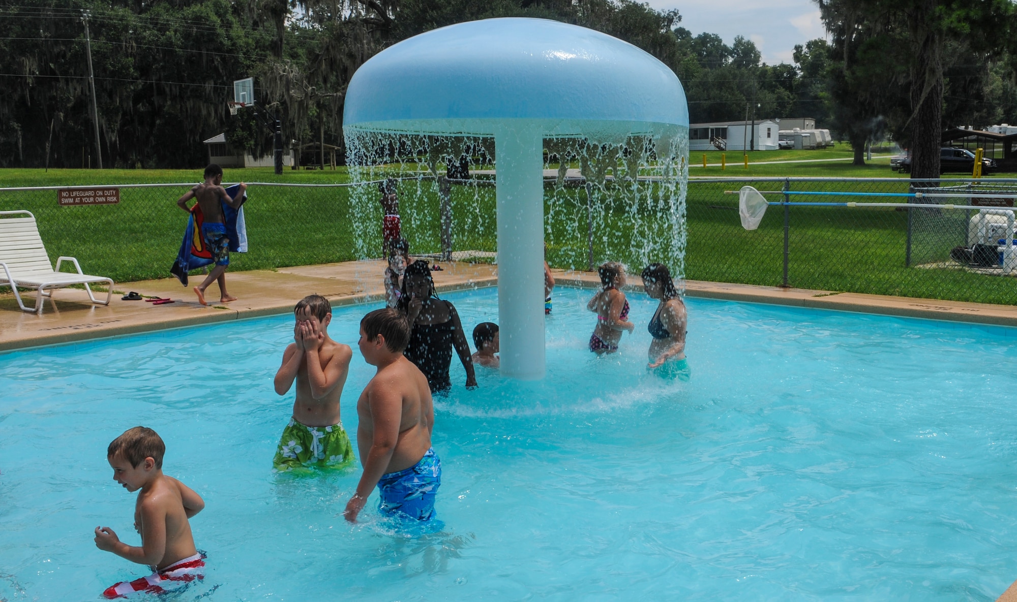 Children splash around in the wade pool at Grassy Pond Lakeland Ga., July 27, 2013. Grassy Pond is a military-only recreational facility that offers a variety of equipment for land and water activities.(U.S. Air Force photo by Airman Alexis Grotz/Released)