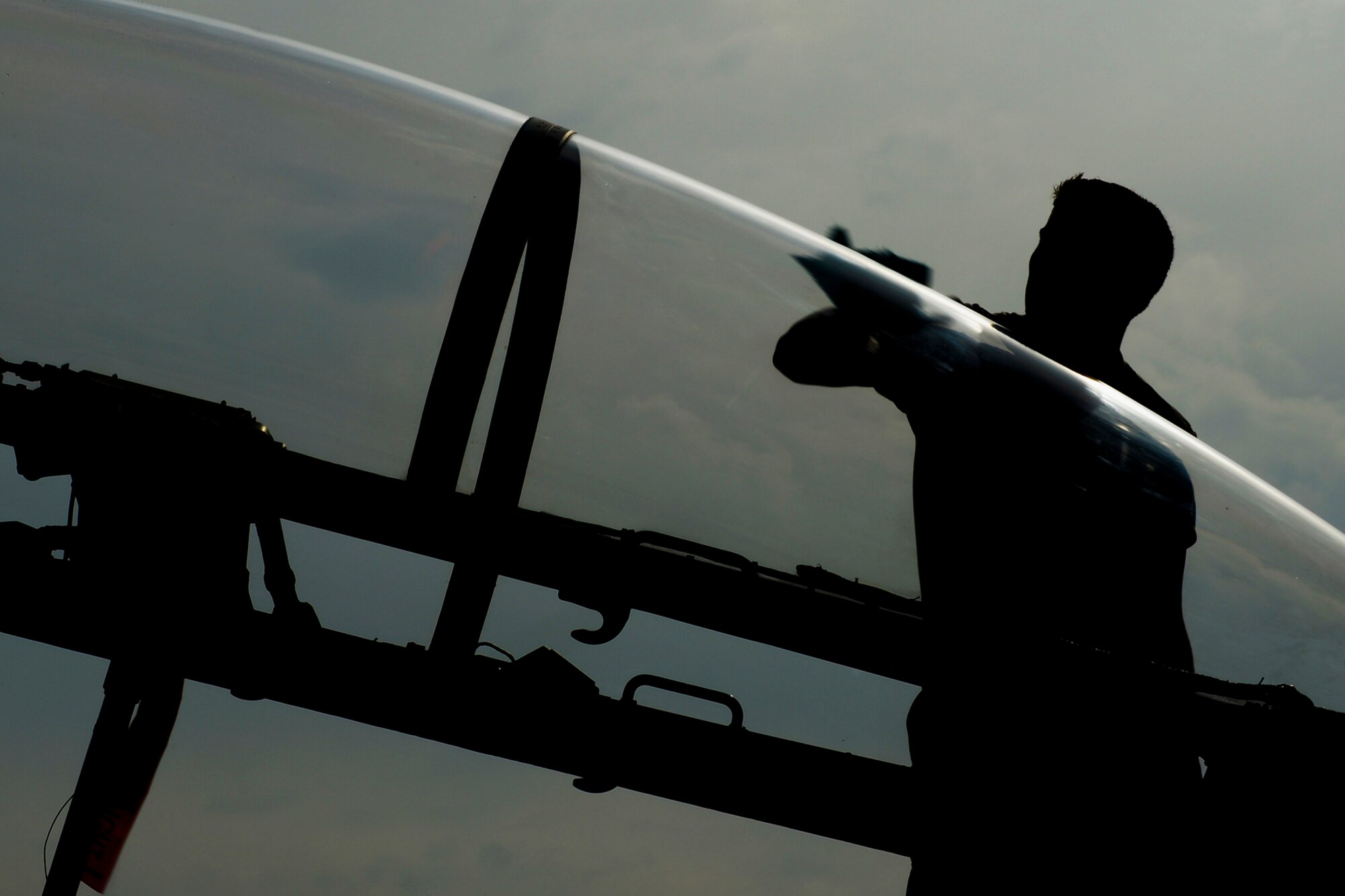 Senior Airman Roland Goncalves, 494th Aircraft Maintenance Unit assistant dedicated crew chief, wipes down the canopy of an F-15 Eagle at Royal Air Force Lakenheath, England, July 24, 2013.  Airmen from the 48th Maintenance Group and 48th Logistics Readiness Squadron were preparing for an upcoming Logistics Compliance Assessment Program inspection. The five-day inspection focuses on checklist compliance, quality verification inspections and personnel evaluations within different units. (U.S. Air Force photo by Airman 1st Class Dana J. Butler/Released)
