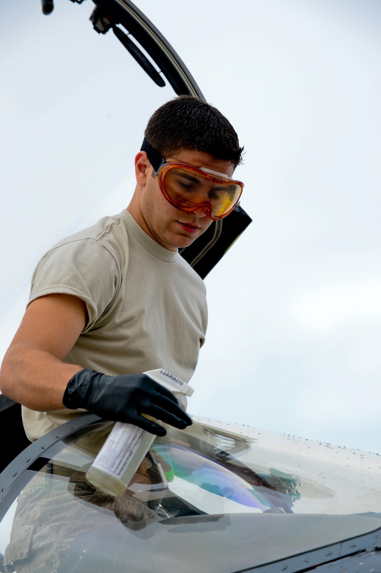 Senior Airman Roland Goncalves, 494th Aircraft Maintenance Unit assistant dedicated crew chief, wipes down the canopy of an F-15 Eagle at Royal Air Force Lakenheath, England, July 24, 2013.  Airmen from the 48th Maintenance Group and 48th Logistics Readiness Squadron were preparing for an upcoming Logistics Compliance Assessment Program inspection. The five-day inspection focuses on checklist compliance, quality verification inspections and personnel evaluations within different units. (U.S. Air Force photo by Airman 1st Class Dana J. Butler/Released)