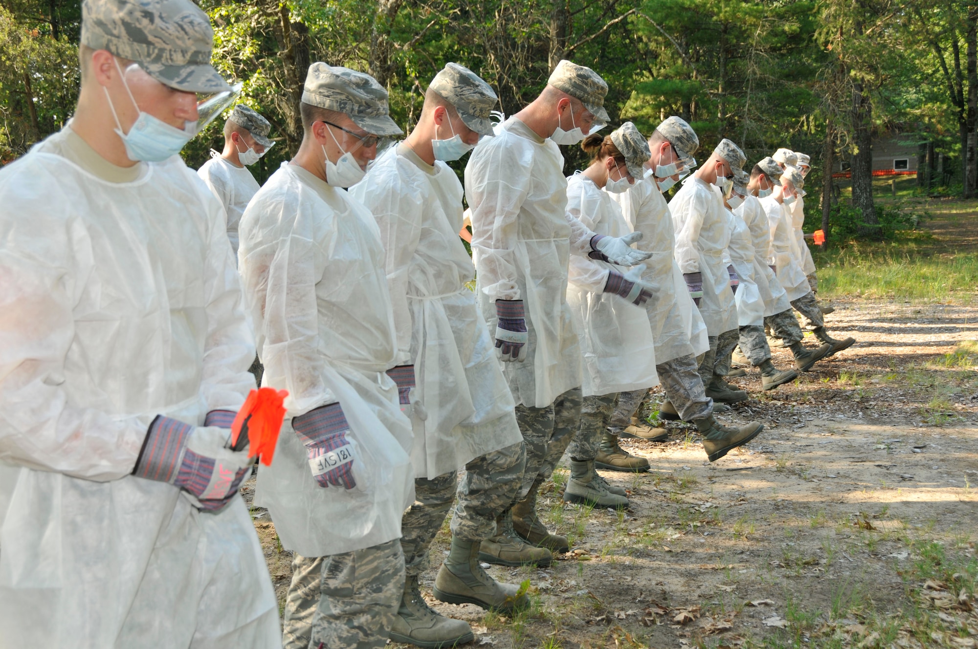 U.S. Airmen with the Indiana Air National Guard, 181st Intelligence Wing Force Support Squadron take one step at a time during a fatality search and rescue exercise July 16, 2013, at the Combat Readiness Training Center, Alpena, Mich. (U.S. Air National Guard photo by Senior Master Sgt. John S. Chapman/Released)