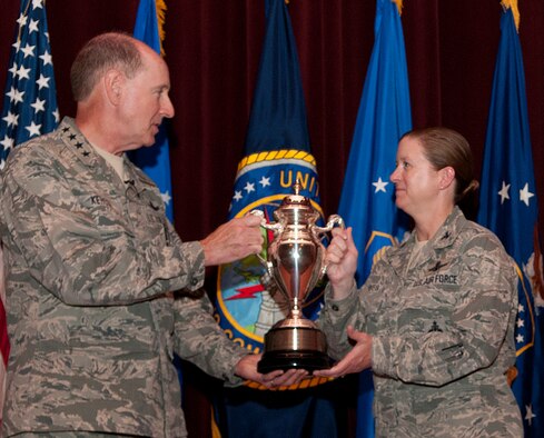 Gen. Robert Kehler, U.S. Strategic Command commander, presents the Omaha Trophy to Col. Tracey Hayes, 90th Missile Wing commander, during an all-call at the F.E. Warren Air Force Base, Wyo., theater July 30, 2013. The Omaha Trophy is awarded to the best missile wing in USSTRATCOM. (U.S. Air Force photo by R.J. Oriez) 
