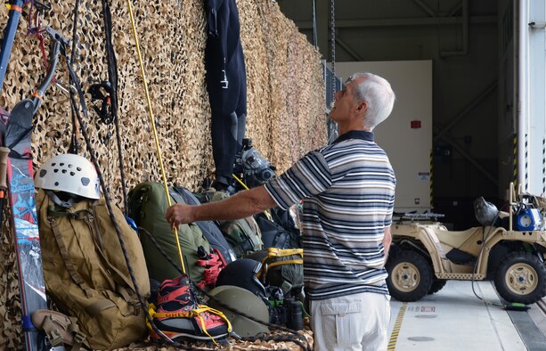 A visitor at the 304th Rescue Squadron reunion picnic checks out a display of pararescue gear at Portland International Airport, Ore., July 28, 2013. The 304th Rescue Squadron is a geographically separated unit of the 920th Rescue Wing, Patrick Air Force Base, Fla. (U.S. Air Force photo/Tech. Sgt. Anna-Marie Wyant)