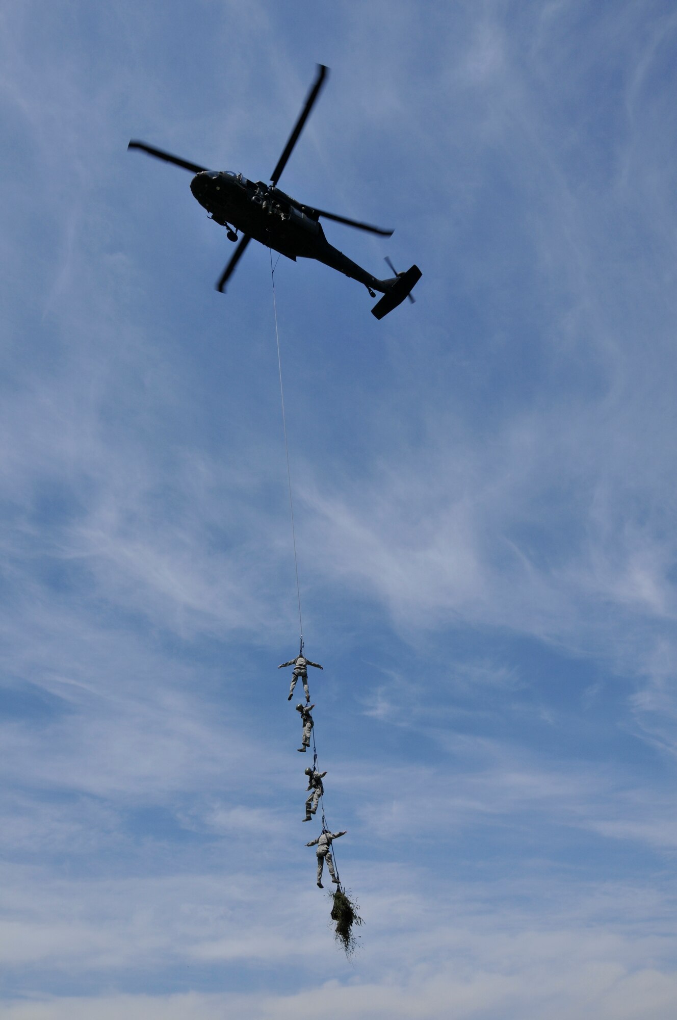 U.S. Air Force members from the 181st Intelligence Wing, Security Forces Squadron, (top to bottom): Capt. John F. Mutnansky; Airmen 1st Class Candace M. Cutler, Tech. Sgt. Richard J. Tryon and Master Sgt. Donald L. Grassick, perform Special Patrol Infiltration Exfiltration System (SPIES) training on a UH60 Blackhawk helicopter at Camp Atterbury, Edinburgh, Ind., on May 15, 2013. Security Forces went to participate in multi-agency law enforcement training event which promotes better communications between agencies and allows for additional skill sets directly related to the Air National Guard's missions of Homeland Security and Domestic Operations.  (U.S. Air National Guard photo by Senior Master Sgt. John S. Chapman/Released)