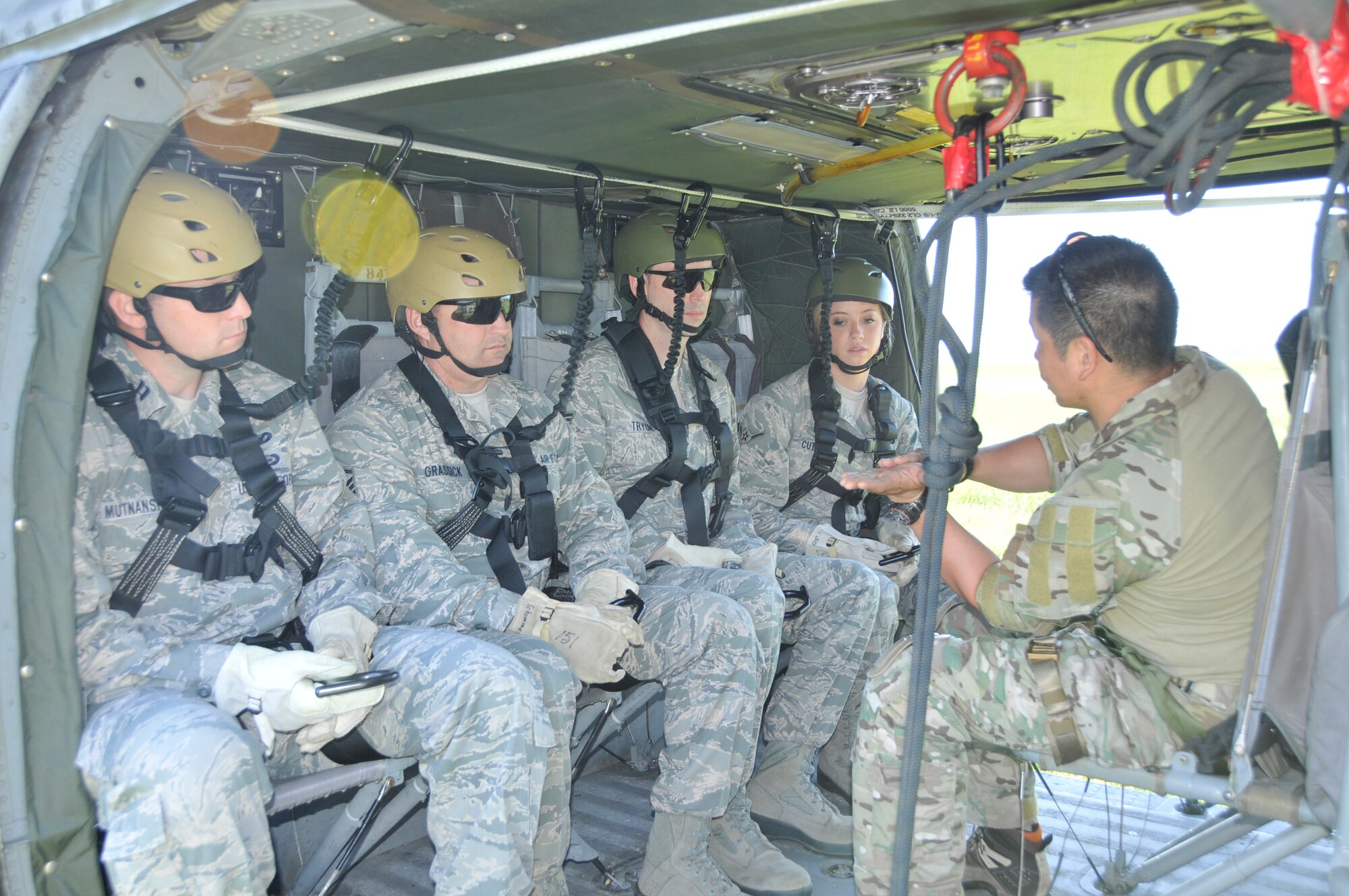 U.S. Air Force members from the 181st Intelligence Wing, Security Forces Squadron, (LtoR): Capt. John F. Mutnansky; Master Sgt. Donald L. Grassick; Tech. Sgt. Richard J. Tryon and Airmen 1st Class Candace M. Cutler, get their final brief before they attempt the 80 foot elevator lift on board a UH60 Blackhawk helicopter at Camp Atterbury, Edinburgh, Ind., on May 15, 2013. Security Forces went to participate in multi-agency law enforcement training event which promotes better communications between agencies and allows for additional skill sets directly related to the Air National Guard's missions of Homeland Security and Domestic Operations.  (U.S. Air National Guard photo by Senior Master Sgt. John S. Chapman/Released)