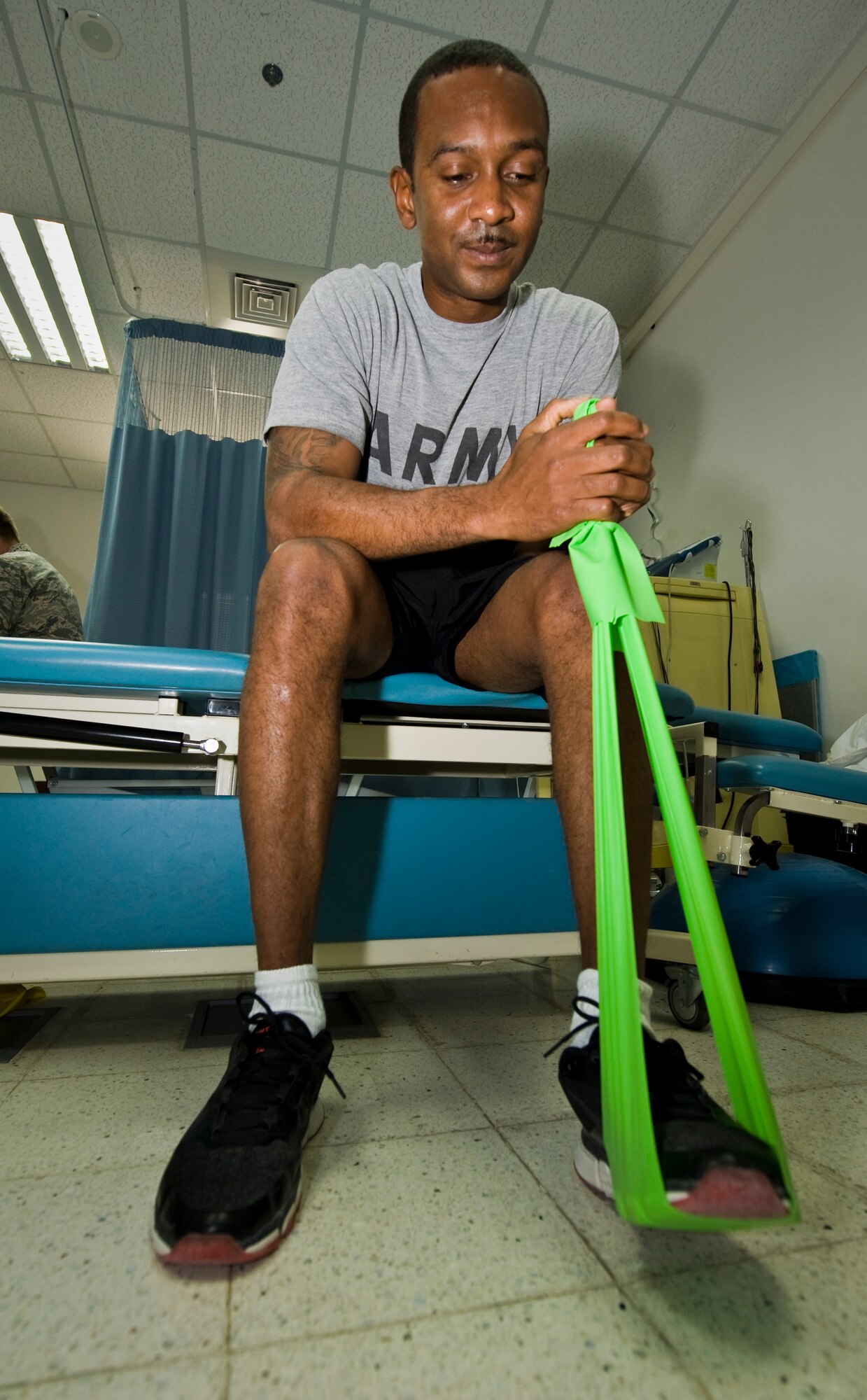 U.S. Army Spc. Demetrius Payton completes physical therapy exercises at the 379th Air Expeditionary Wing in Southwest Asia, July 24, 2013. Payton is a motor vehicle operator who injured himself during convoy operations in Afghanistan and has been recovering at the Intra-Theater Care Program here. (U.S. Air Force photo/Senior Airman Benjamin Stratton)