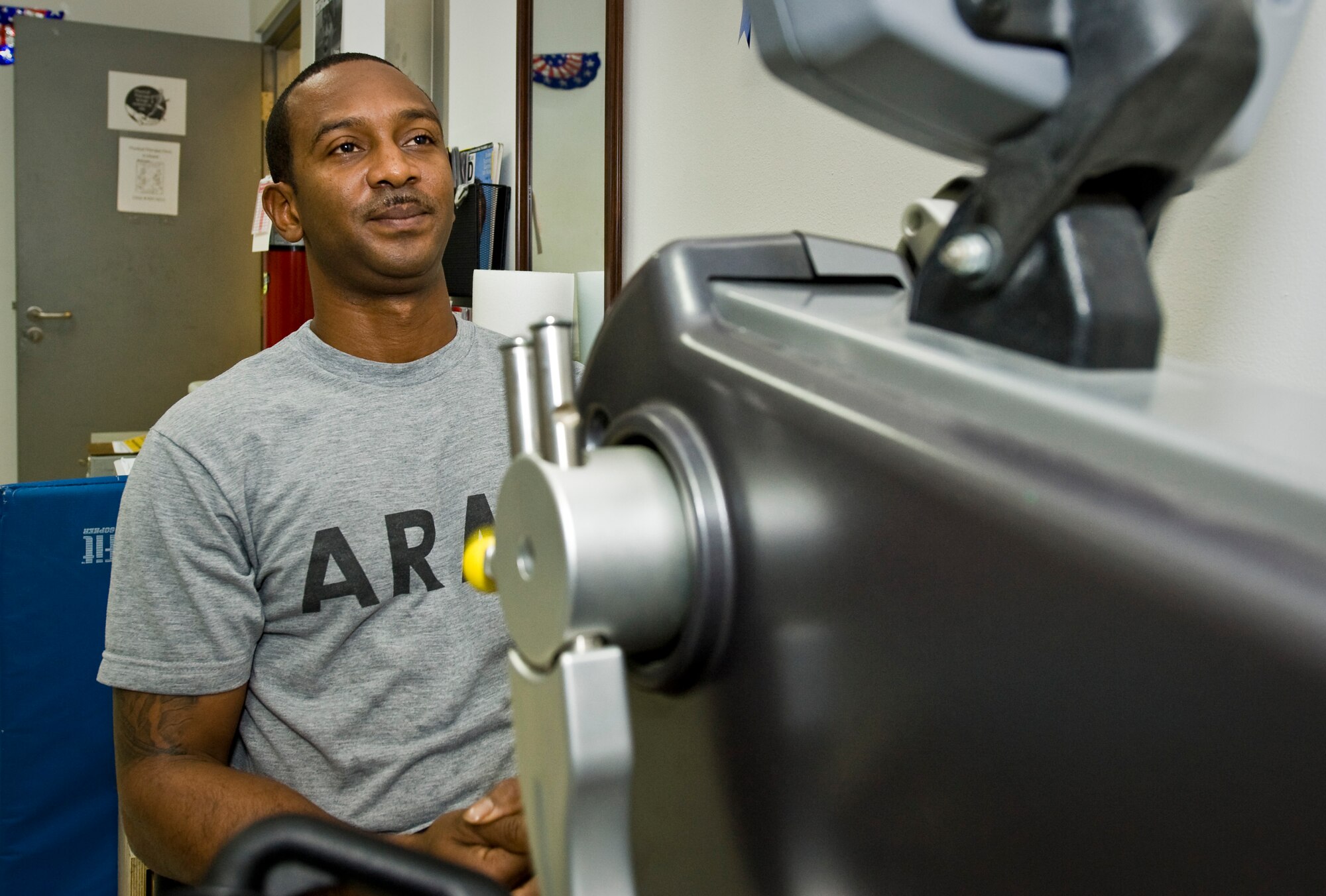 U.S. Army Spc. Demetrius Payton warms up his muscles prior to physical therapy at the 379th Air Expeditionary Wing in Southwest Asia, July 24, 2013. Payton is a motor vehicle operator who injured himself during convoy operations in Afghanistan and has been recovering at the Intra-Theater Care Program here. (U.S. Air Force photo/Senior Airman Benjamin Stratton)