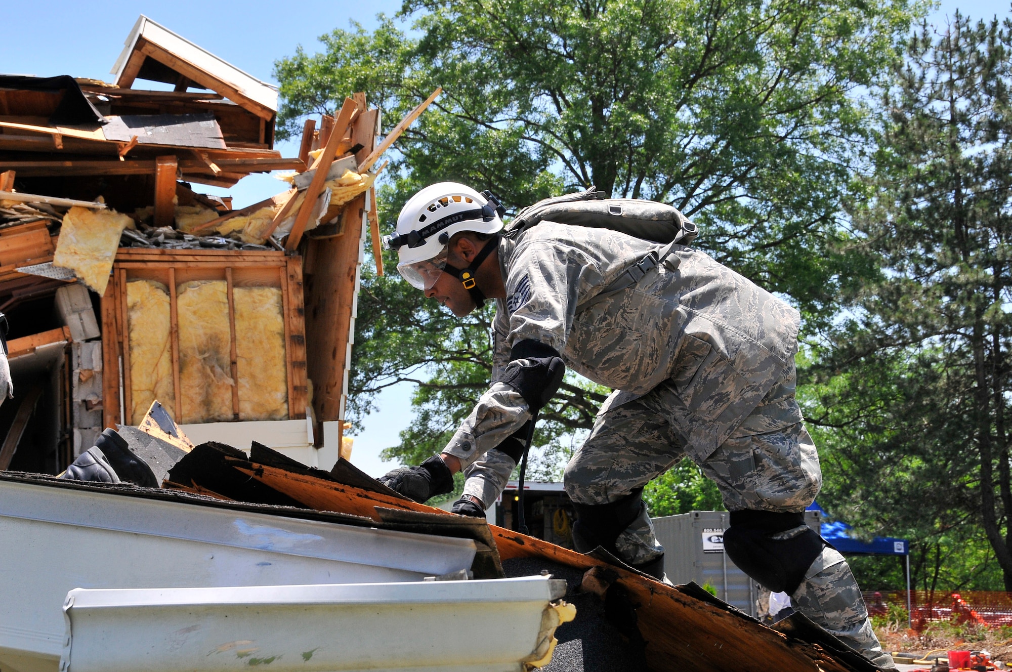 Air Force Tech. Sgt. Isadore C. Gurnell, 181st Intelligence Wing, Force Support Squadron, climbs on top of a collapse roof looking for victims at Indiana University, Bloomington, Ind., June 11, 2013. The training conducted at Indiana University involved Air and Army Guardsmen, Bloomington Fire Department and Israelis Search and Rescue team in an exercise called United Front II. (U.S. Air National Guard photo by Senior Master Sgt. John S. Chapman/Released)