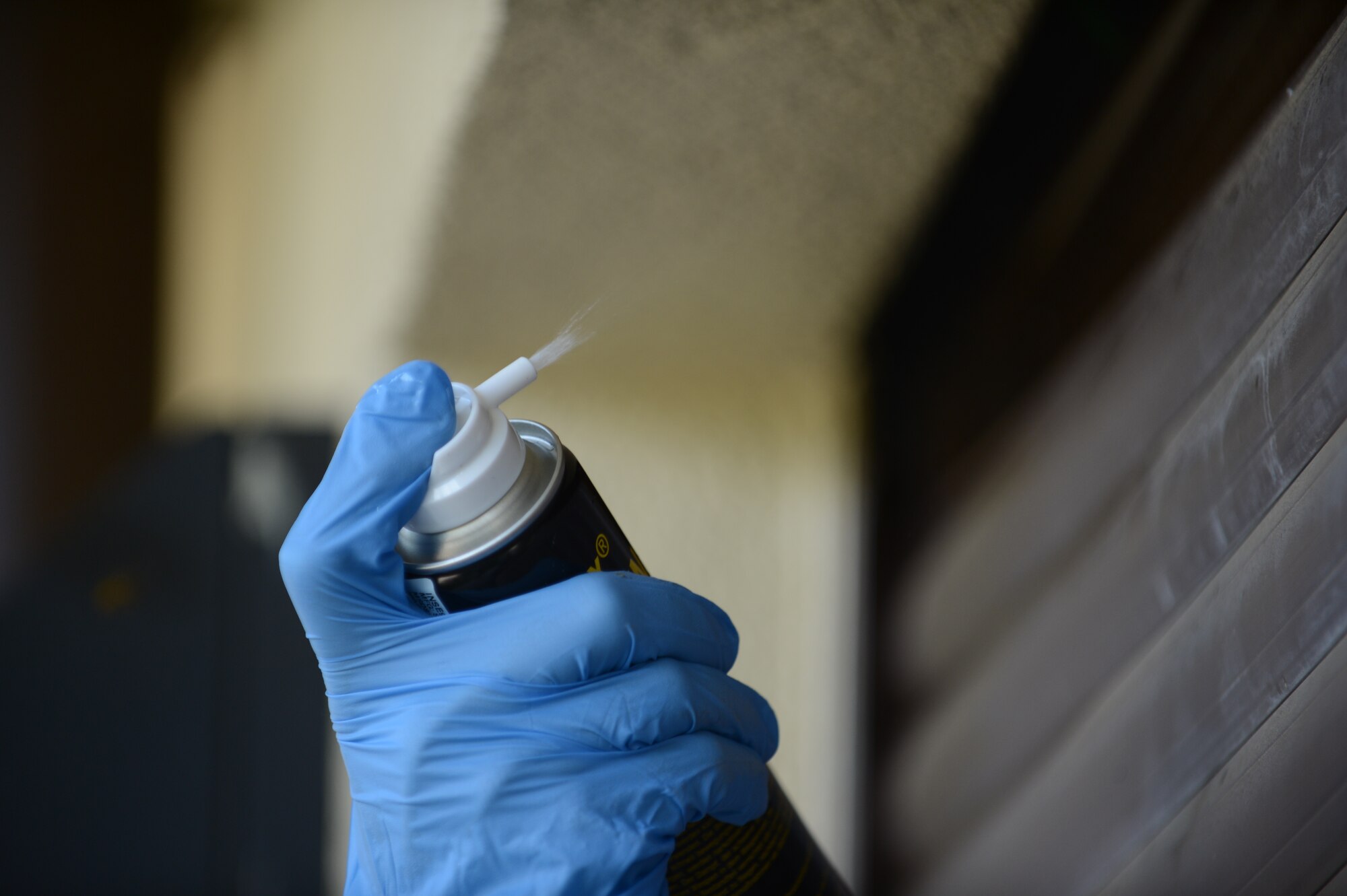 SPANGDAHLEM AIR BASE, Germany – U.S. Air Force Airman 1st Class Dustin Pavlenko, 52nd Civil Engineer Squadron pest controller from Moorcroft, Wyo., sprays a wasp nest with a chemical spray July 23, 2013. Pest controllers spray the bees with an environmentally friendly chemical spray to kill the nest. Upon request pest controllers will give an educational briefing to school children about harmful pests. (U.S. Air Force photo by Airman 1st Class Gustavo Castillo/Released)