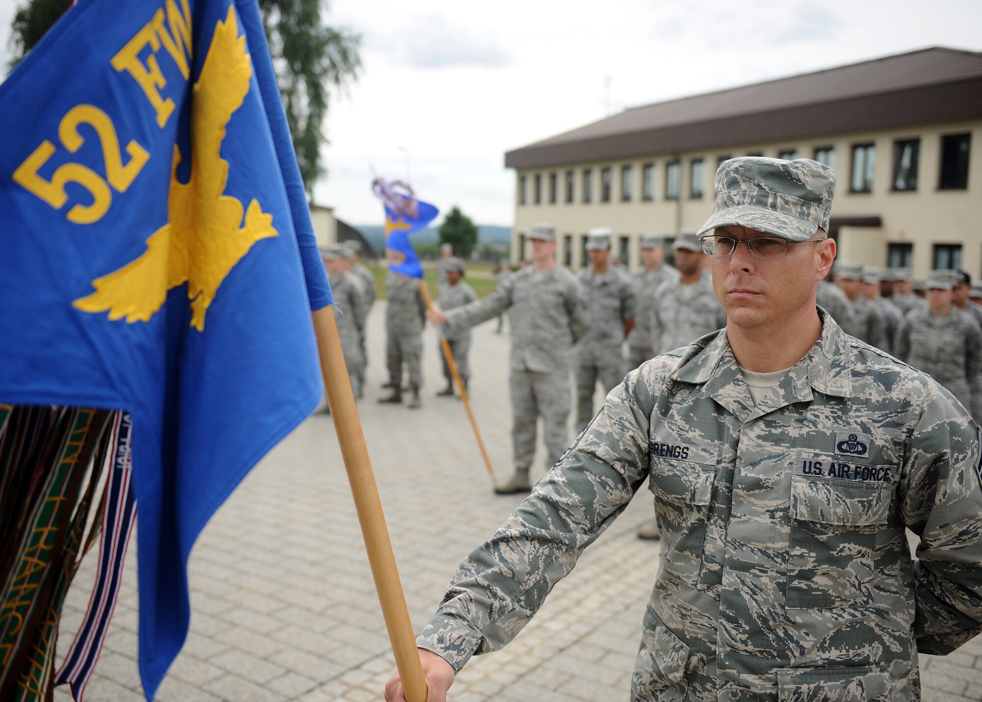 SPANGDAHLEM AIR BASE, Germany – U.S. Air Force Chief Master Sgt. Matthew Grengs, 52nd Fighter Wing command chief master sergeant, holds the wing’s guidon during a new wing retreat ceremony July 29, 2013. Representatives from several base units stood in formation to honor Germany and the United States during the playing of their national anthems. This retreat ceremony is scheduled for once a month during the summer. (U.S. Air Force photo by Staff Sgt. Daryl Knee/Released)