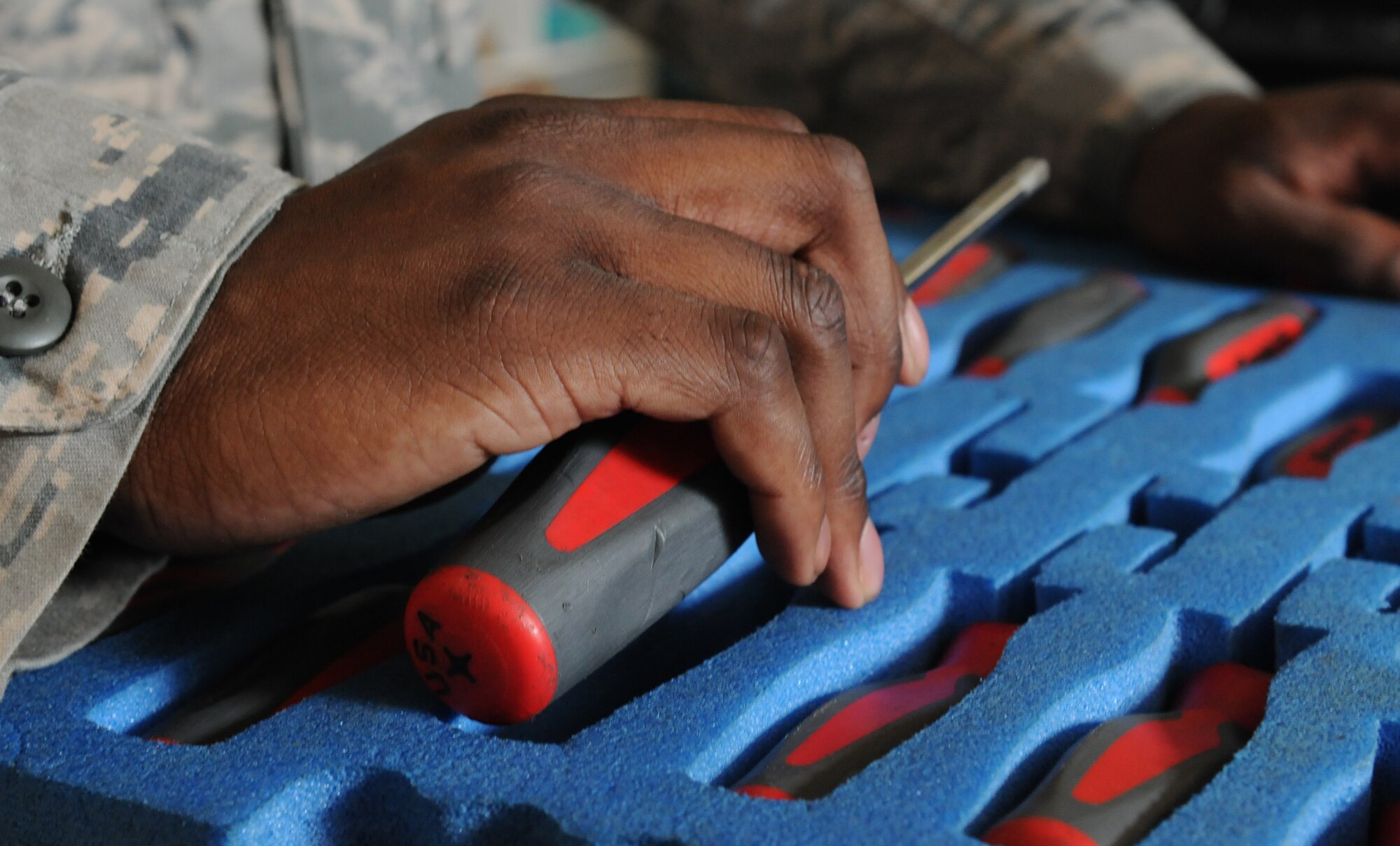 Senior Airman Markus Alleyne, 86th Aircraft Maintenance Squadron consolidated tool kit custodian, inspects equipment, July 23, 2013, Ramstein Air Base, Germany. Alleyne is part of the 86th AMXS Sortie Support Flight who was recently named “Innovator of the Month” for their efforts to enhance quality of life in the work place, reduce spending and creating time-saving materials and shipping methods. (U.S. Air Force photo/Airman 1st Class Holly Mansfield)