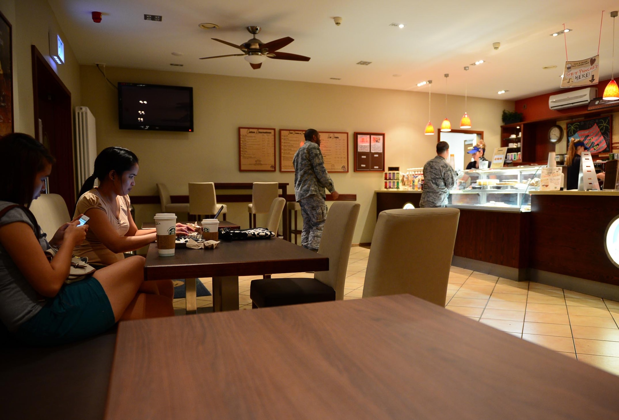 SPANGDAHLEM AIR BASE, Germany – Kathleen Arenas and Katherine Maala use the new furniture in Kuhl Beanz July 29, 2013. Kuhl Beanz received new furnishing July 5, 2013. In the past year, Kuhl Beanz served more than 127,000 cups of coffee. The overall renovation of the Saber Conference Center included the relocation of Toni’s Gift Shop and official renaming of the conference rooms. The Golden Dragon restaurant redesign will begin in September and is projected to be finished in October 2013. (U.S. Air Force photo by Airman 1st Class Kyle Gese/Released)
