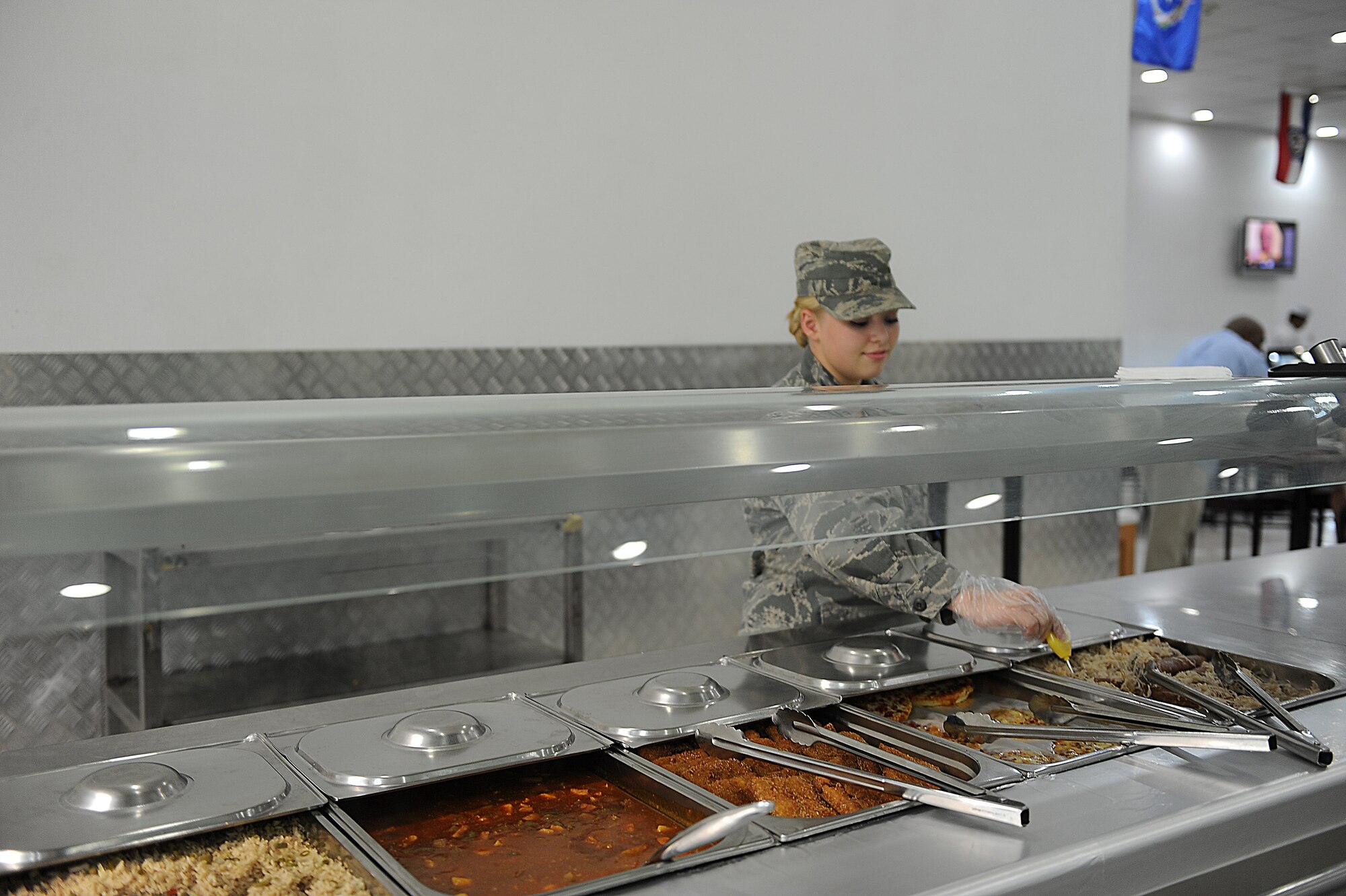Airman Samantha Dahl, 386th Expeditionary Force Support Squadron, takes the temperature of food at the Desert Winds dining facility (DFAC).  Dahl can commonly be seen at the entrance of the DFAC welcoming everyone with a smile.  She has been chosen as this week's Rock Solid Warrior.  ( U.S. Air Force photo by Master Sgt. Marelise Wood)