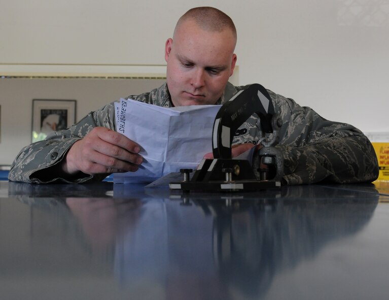 Staff Sgt. Matthew Mans, 86th Aircraft Maintenance Squadron consolidated tool kit custodian, inspects equipment, July 23, 2013, Ramstein Air Base, Germany. Mans is part of the 86th AMXS Sortie Support Flight who was recently named “Innovator of the Month” for their efforts to enhance quality of life in the work place, reduce spending and creating time-saving materials and shipping methods. (U.S. Air Force photo/Airman 1st Class Holly Mansfield)