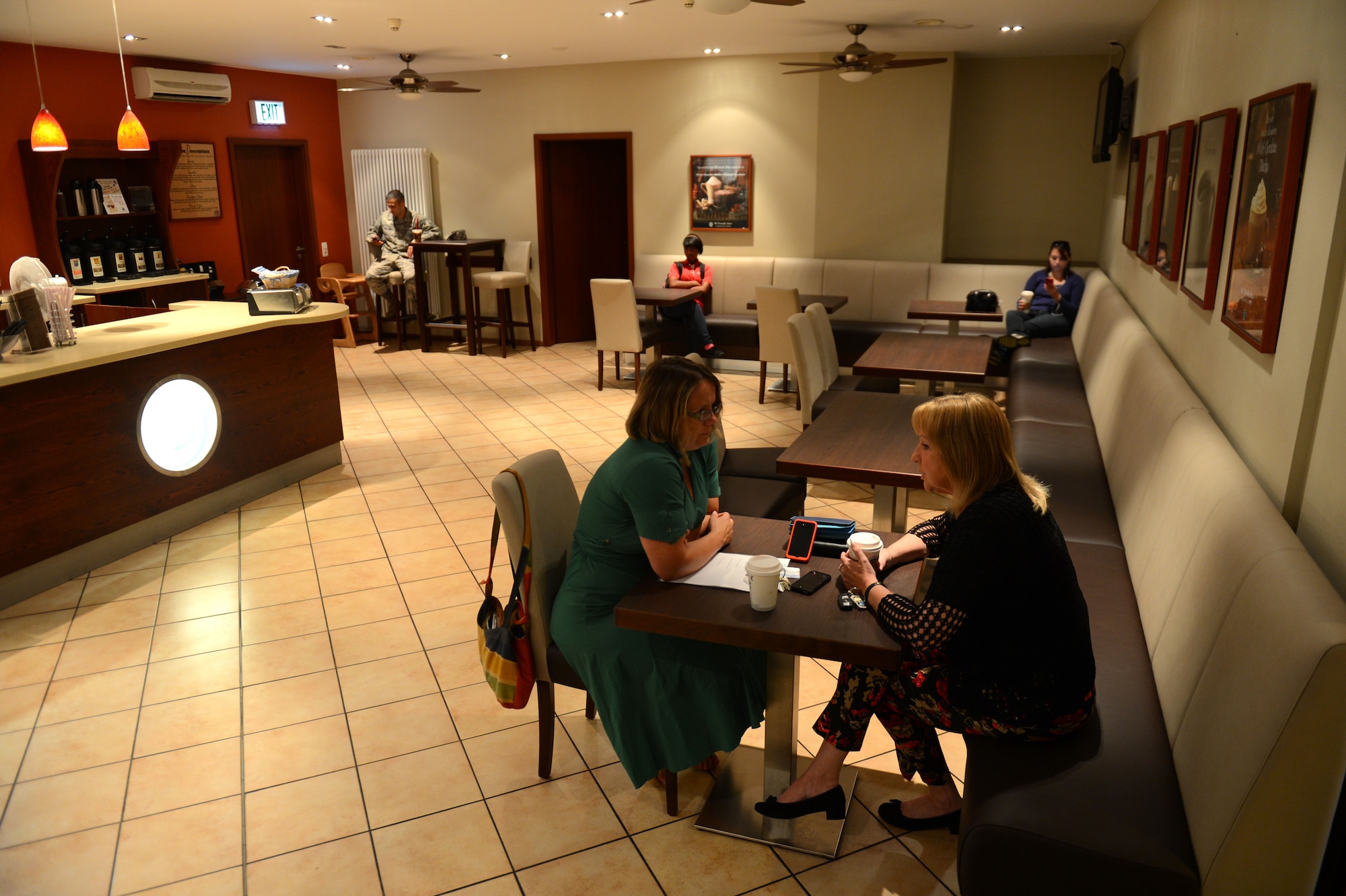 SPANGDAHLEM AIR BASE, Germany – People enjoy coffee in the newly renovated Saber Conference Center July 29, 2013. The Saber Conference Center is a focal point for new members when arriving to Spangdahlem due to it being the location of newcomer briefings. The Kuhl Beanz coffee shop received new seating as part of a renovation project funded through the Nonappropriated Fund Small Projects Program, which is money generated through sales at 52nd Force Support Squadron facilities versus tax-payer dollars. (U.S. Air Force Airman 1st Class Gustavo Castillo/Released)