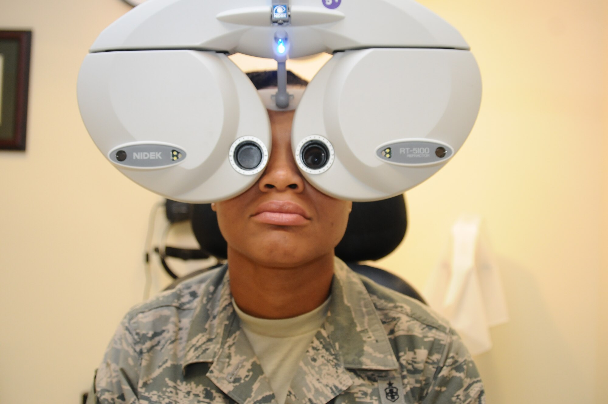 Master Sgt. Tamika Thomas, 36th Medical Operations Squadron aerospace medicine flight chief, receives a refractor test to determine her lens prescription July 31, 2013, on Andersen Air Force Base, Guam. The 36th Medical Group upgraded to an electronic refractor, which is more efficient than the previous manual refractors. (U.S. Air Force photo by Airman 1st Class Emily A. Bradley/Released)