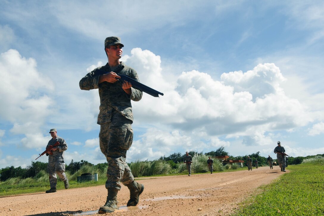 Airman 1st Class James Holland-Crespo, 36th Civil Engineer Squadron electrical power production apprentice, patrols an area while training July 29, 2013, on Northwest Field, Guam. Dismounted operations training is a requirement prime Base Emergency Engineer Force Airmen have to complete to meet their deployment readiness standards. (U.S. Air Force photo by Airmen 1st Class Emily A. Bradley/Released)

