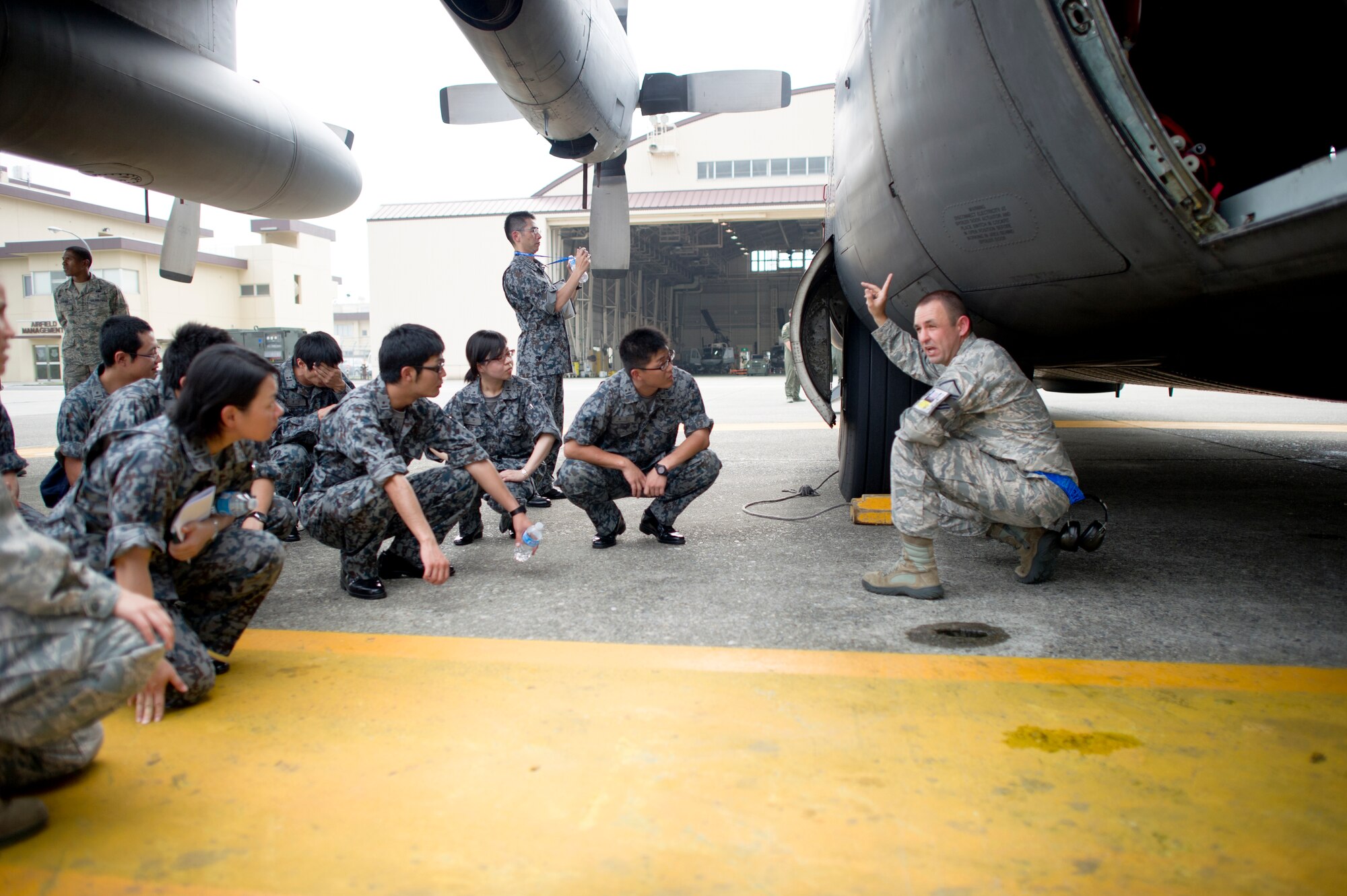 YOKOTA AIR BASE, Japan -- Master Sgt. Anthony Boyer, 374th Aircraft Maintenance Squadron, gives Japan Air Self-Defense Force maintenance officers a tour of a C-130 Hercules at Yokota Air Base, Japan, July 26, 2013. The officers visited Yokota as part of an officer exchange program. - (U.S. Air force photo by Staff Sgt. Stacy Moless)