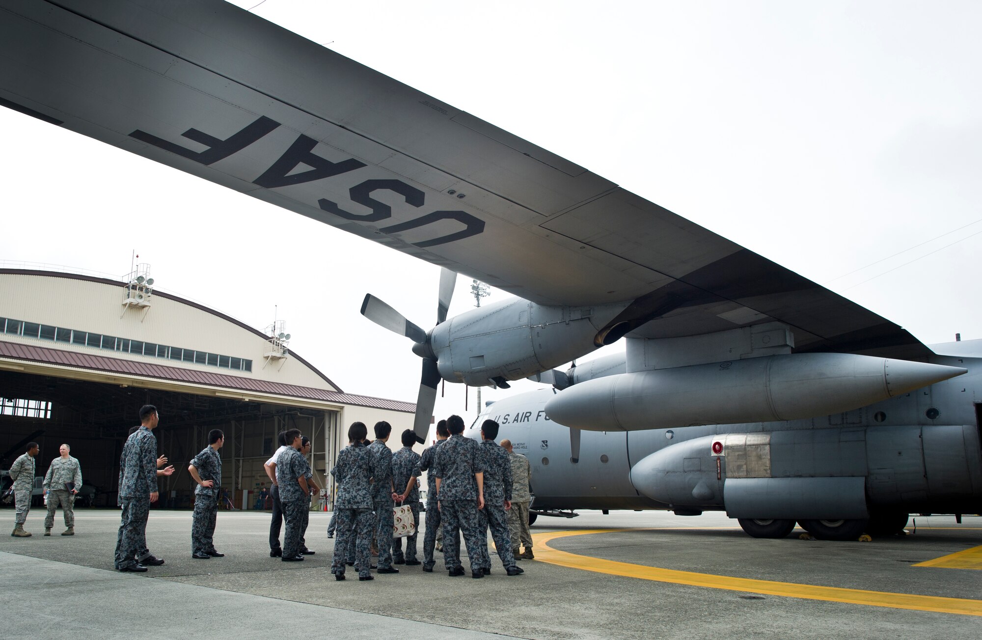 YOKOTA AIR BASE, Japan -- Japan Air Self-Defense Force maintenance officers receive a tour of a C-130 Hercules at Yokota Air Base, Japan, July 26, 2013, during an officer exchange program. During the visit, the officers toured several shops to learn about their procedures and equipment. (U.S. Air force photo by Staff Sgt. Stacy Moless)