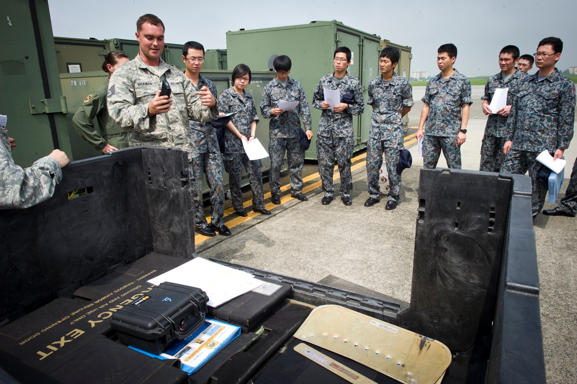 YOKOTA AIR BASE, Japan -- Staff Sgt. Luke Hickman, 374th Aircraft Maintenance Squadron, briefs Japan Air Self-Defense Force maintenance officers at Yokota Air Base, Japan, July 26, 2013, during an officer exchange program. During the visit, the officers toured several shops to learn about their procedures and equipment. (U.S. Air force photo by Staff Sgt. Stacy Moless)