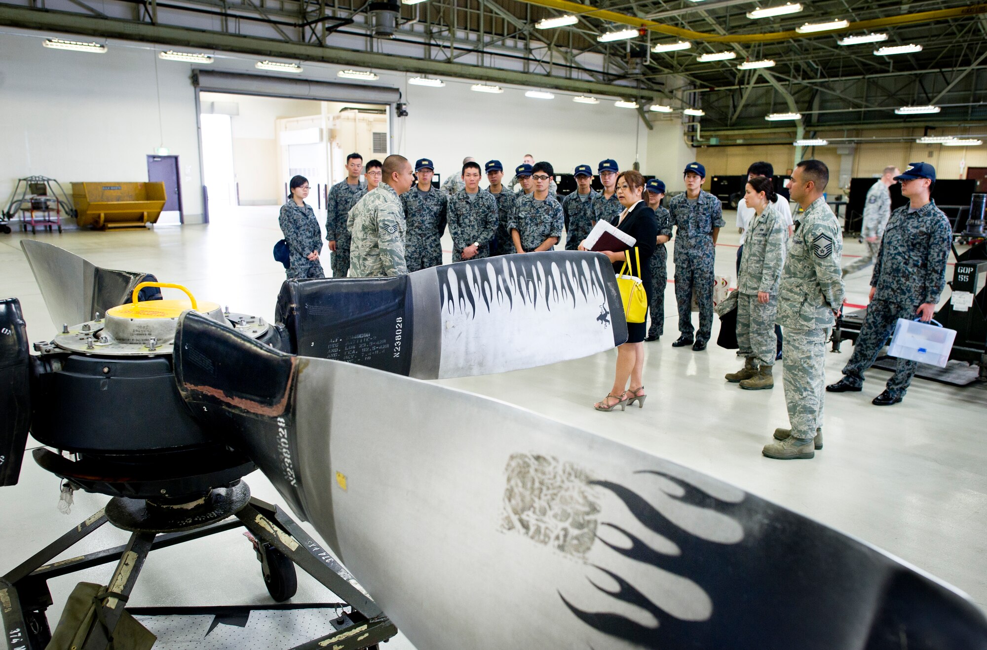 YOKOTA AIR BASE, Japan -- Japan Air Self-Defense Force maintenance officers receive a briefing during a tour of the 374th Maintenance Group at Yokota Air Base, Japan, July 26, 2013. The visiting officers are taking part in an officer exchange program, which gives them the chance to see how maintainers at Yokota work. (U.S. Air force photo by Staff Sgt. Stacy Moless) 