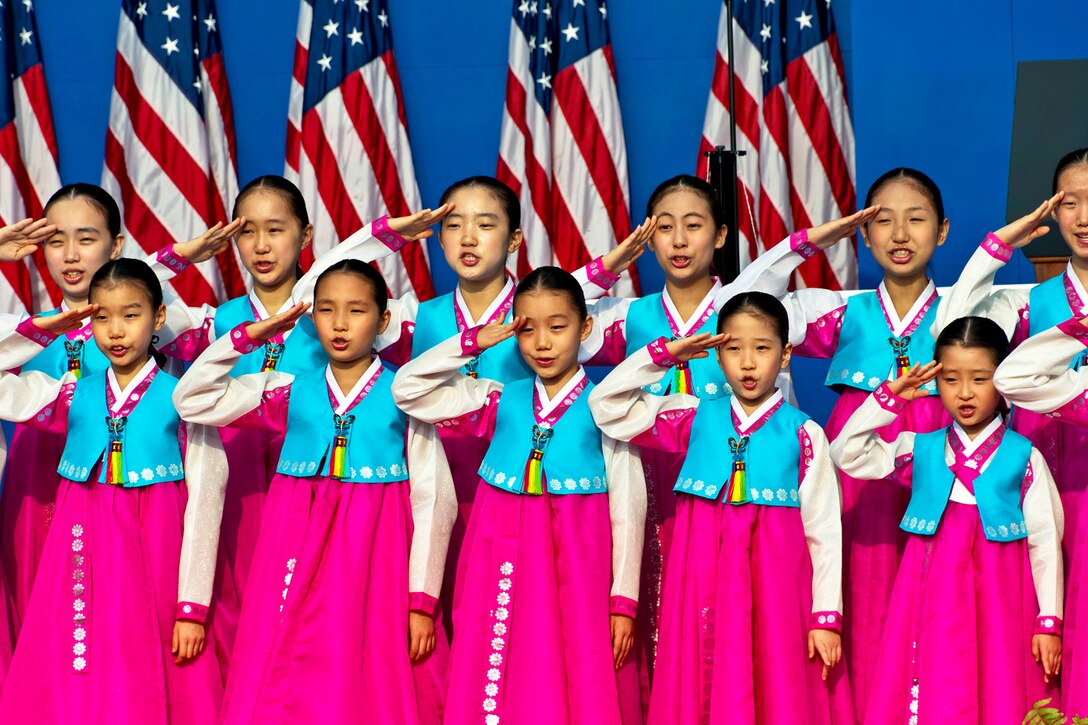 Korean children salute the audience after performing during the ceremony marking the 60th anniversary of the armistice ending the Korean War at the Korean War Memorial in Washington, D.C., July 27, 2013.