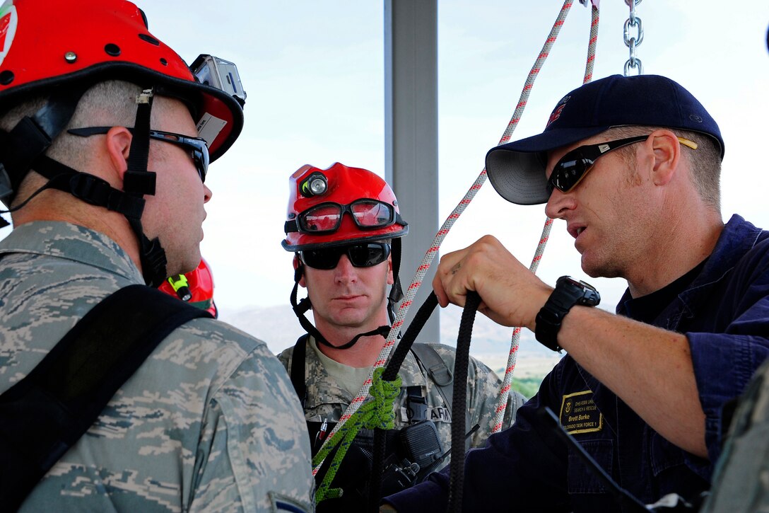 Brett Burke, right, trains soldiers and airmen on rope rescues as part of exercise Vigilant Guard 2013 at the West Metro Fire Training Center in Lakewood, Colo., July 24, 2013. Burke is assigned to Colorado Task Force 1.