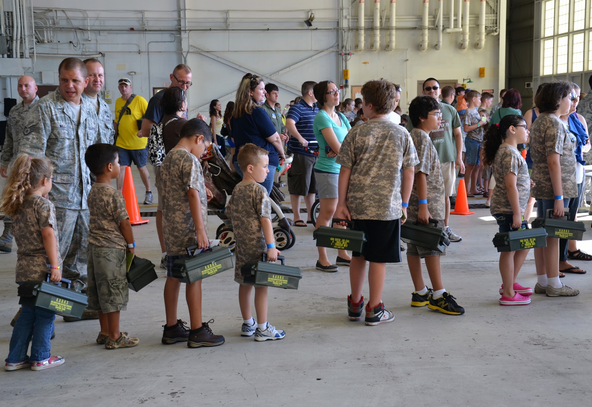 Air Force-dependent children stand in line for camouflage face paint during the Kids Understanding Deployment Operations event at Patrick Air Force Base June 1, 2013. (U.S. Air Force photo/Tech. Sgt. Anna-Marie Wyant)